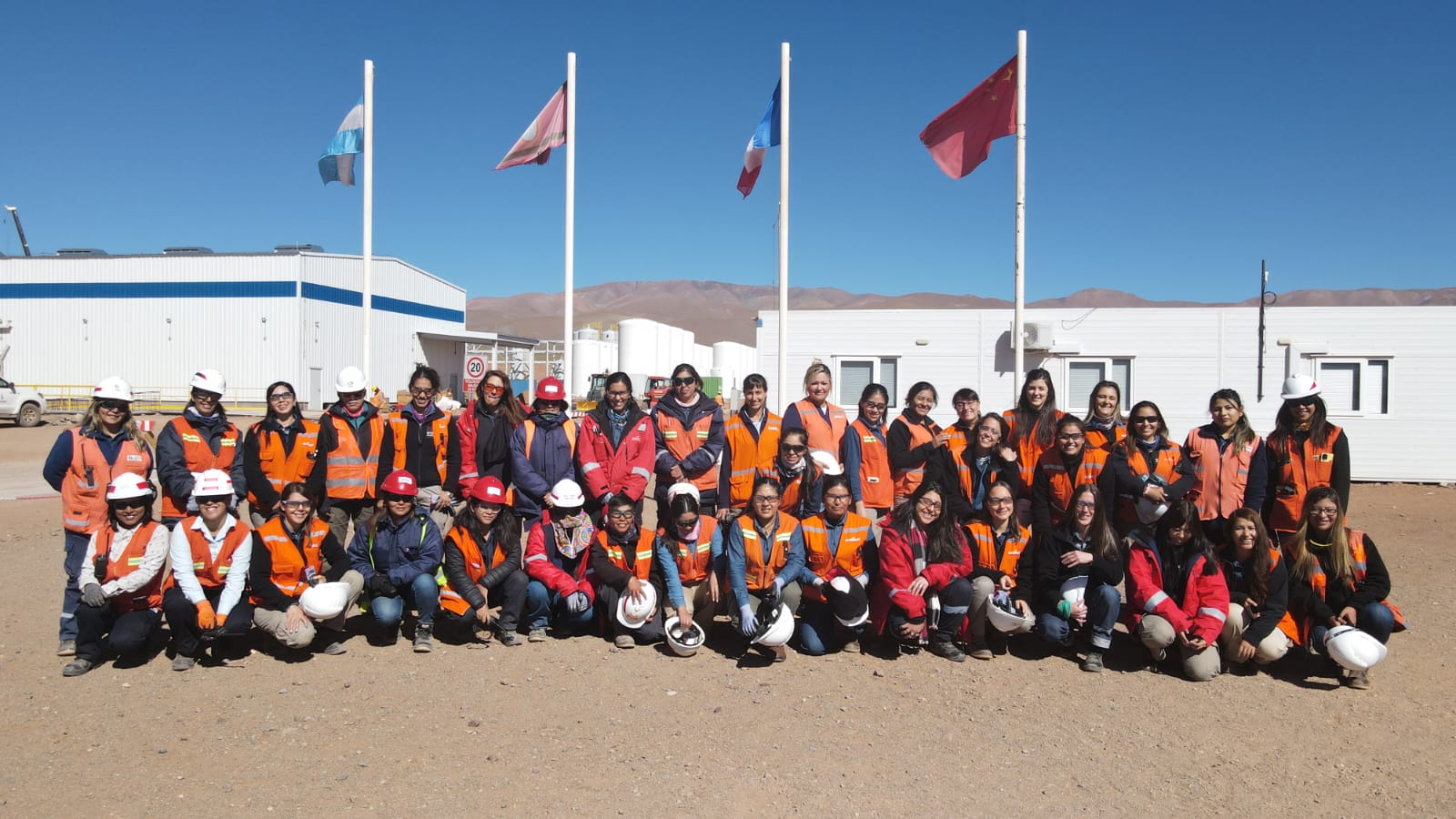 A team of Eramine workers stands in front of the production plant