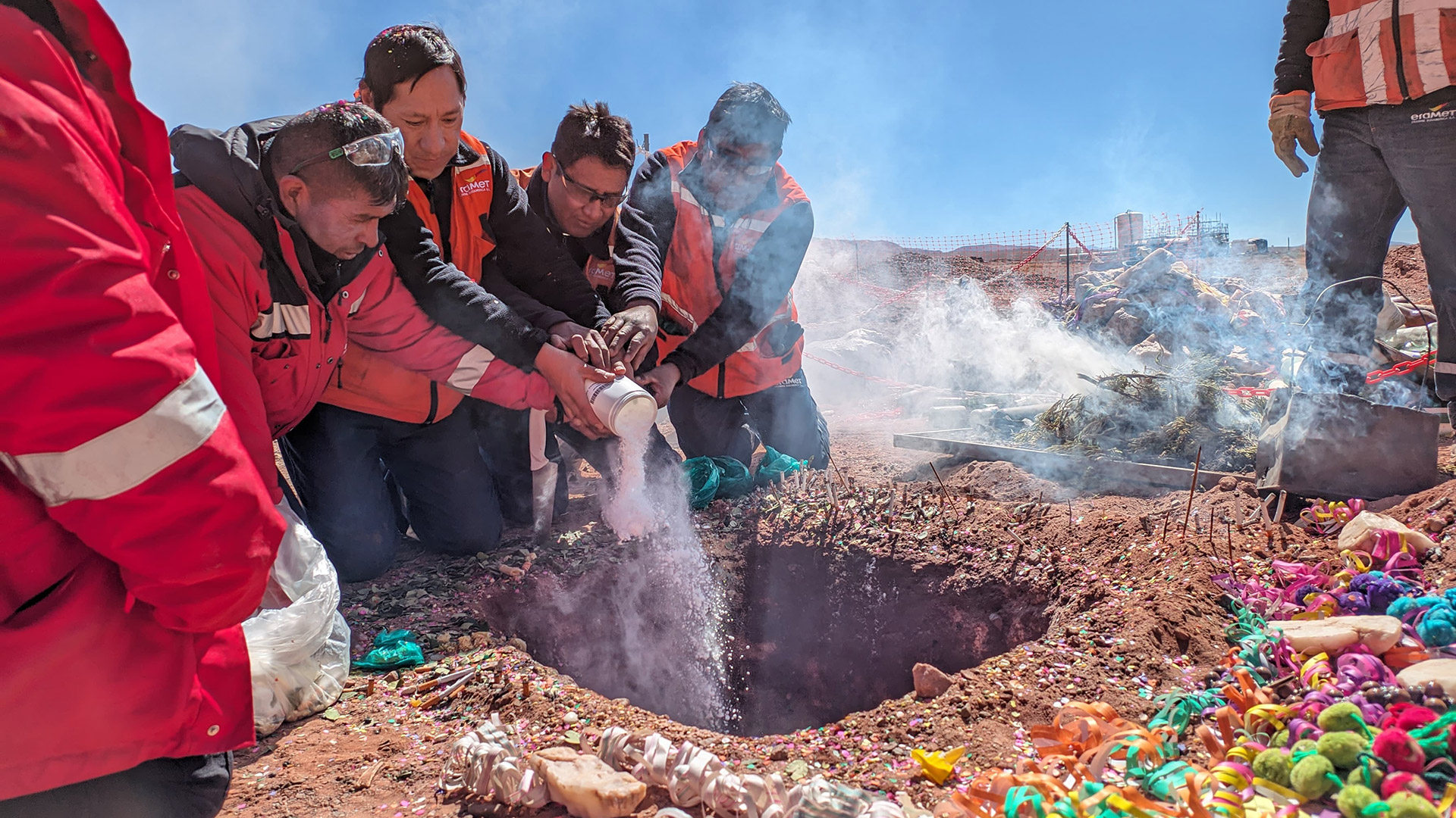 A team of Eramine workers stands in front of the production plant