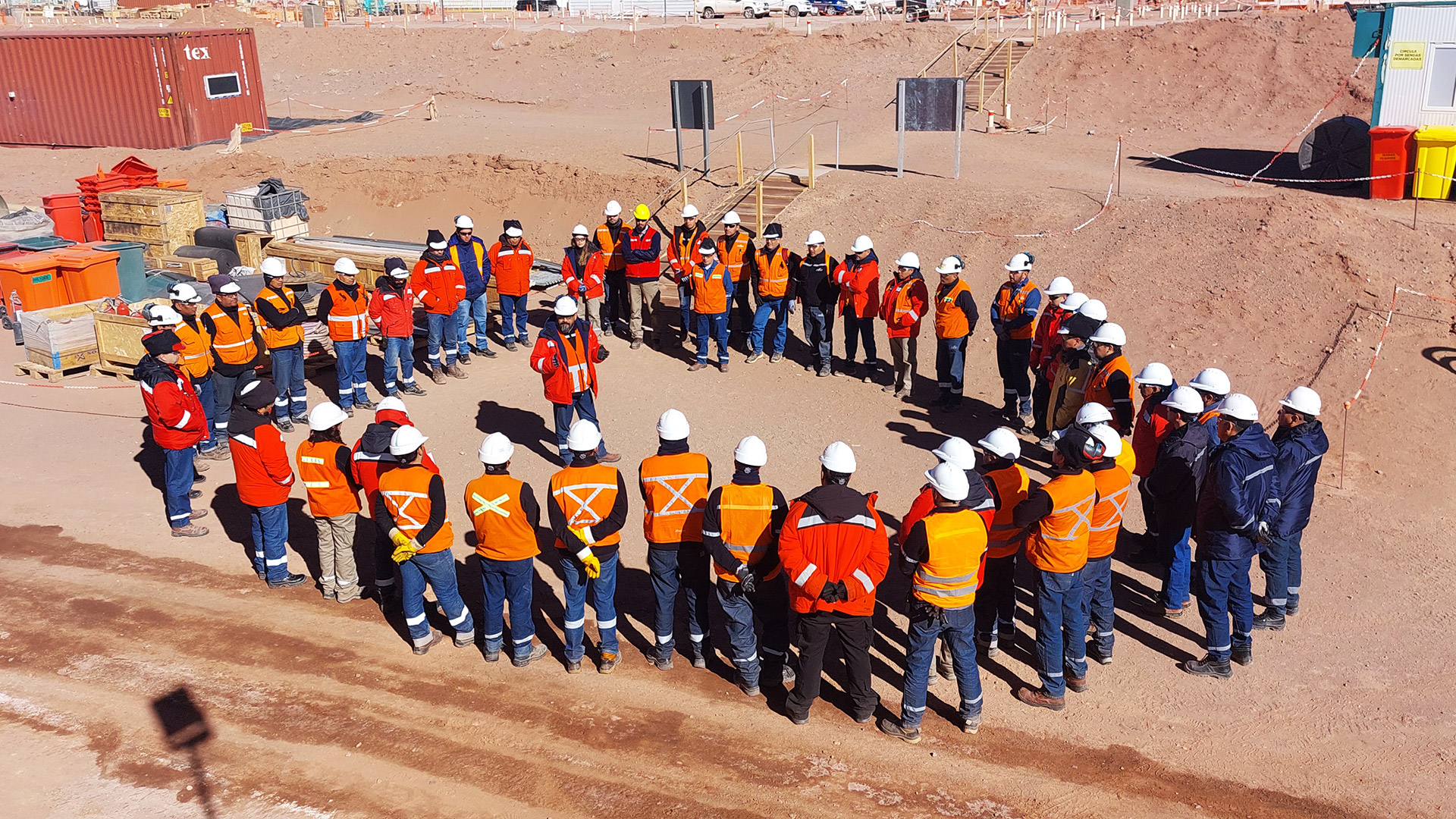 A team of Eramine workers stands in front of the production plant